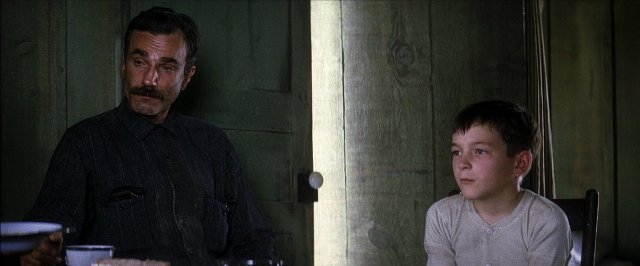Wide shot frame from There Will Be Blood — sitting, room, table