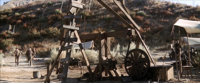 Wide shot frame from There Will Be Blood — walking, wheel, person
