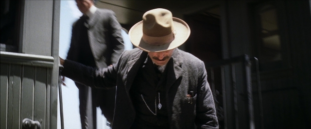 Frame from There Will Be Blood — standing, walking, door
