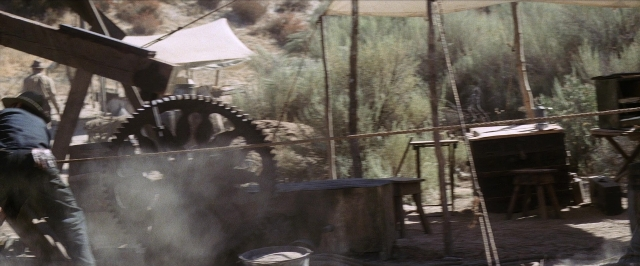 Frame from There Will Be Blood — table, smoke, person