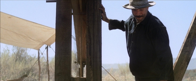 Frame from There Will Be Blood — standing, hat, shirt