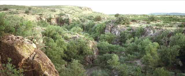 Wide shot frame from There Will Be Blood — action, show, desert