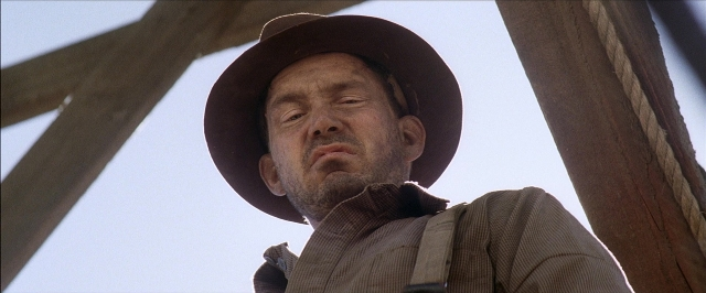Medium shot frame from There Will Be Blood — hat, shirt, beard