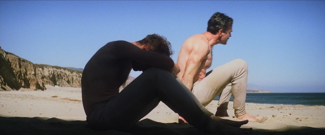 Wide shot frame from There Will Be Blood — sitting, face, sea