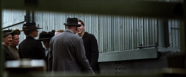 Wide shot frame from There Will Be Blood — standing, room, dialogue