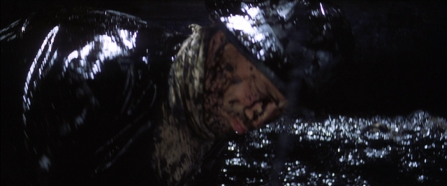 Wide shot frame from There Will Be Blood — animal, water, face