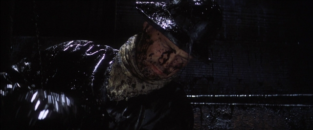 Wide shot frame from There Will Be Blood — standing, room, hat