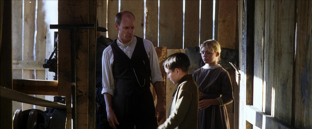 Wide shot frame from There Will Be Blood — standing, room, hand