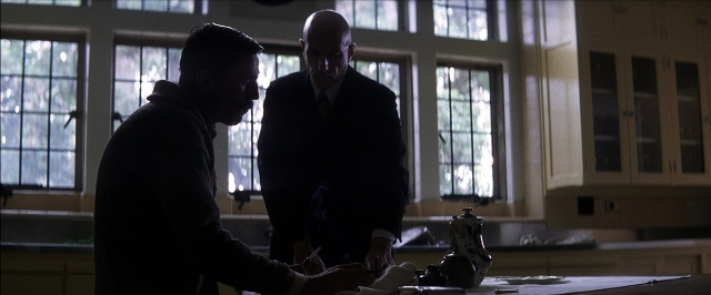 Medium shot frame from There Will Be Blood — standing, table, kitchen