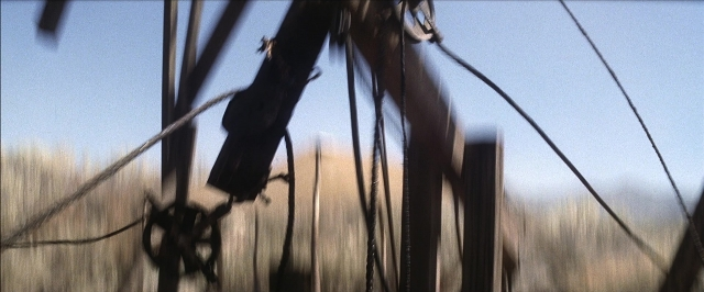 Wide shot frame from There Will Be Blood — phone, car