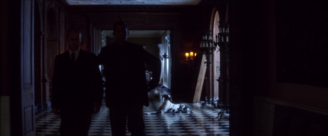 Wide shot frame from There Will Be Blood — standing, room, dog