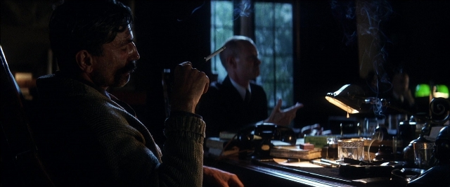 Wide shot frame from There Will Be Blood — sitting, room, table