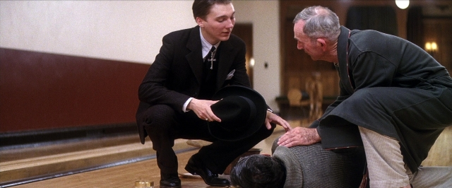 Wide shot frame from There Will Be Blood — sitting, standing, room