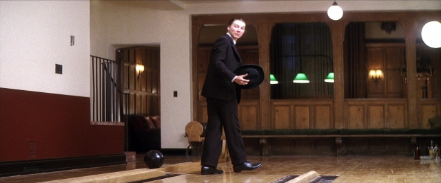 Wide shot frame from There Will Be Blood — standing, room, hat