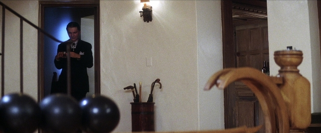 Wide shot frame from There Will Be Blood — standing, dialogue, door