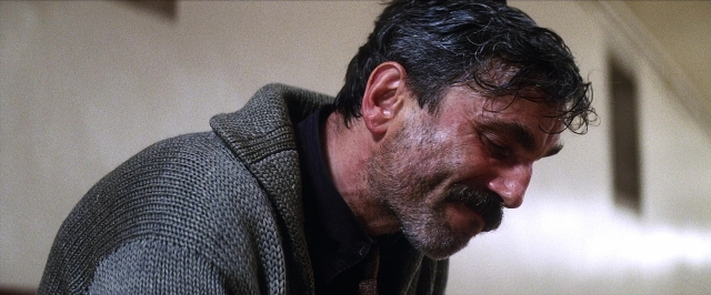 Wide shot frame from There Will Be Blood — shirt, beard, face