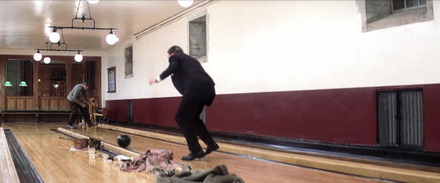 Wide shot frame from There Will Be Blood — standing, hand, suit