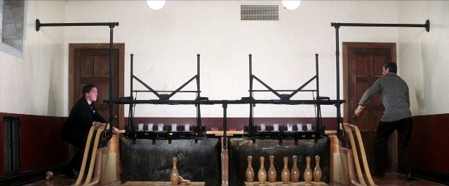 Wide shot frame from There Will Be Blood — standing, room, table