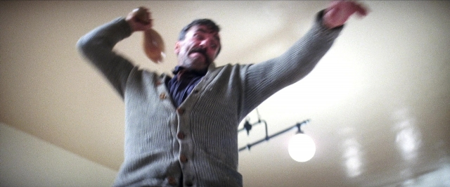 Frame from There Will Be Blood — standing, room, shirt