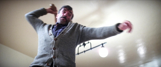 Frame from There Will Be Blood — standing, room, shirt