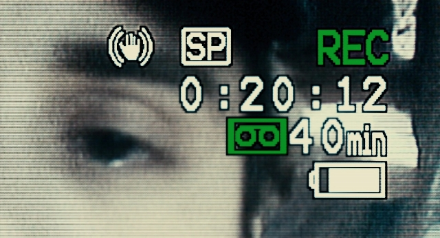 Wide shot frame from 127 Hours — hand, clock, digital clock