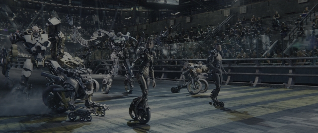 Wide shot frame from Alita: Battle Angel — standing, walking, suit