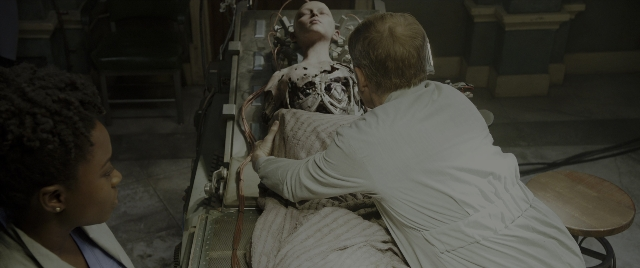 Wide shot frame from Alita: Battle Angel — standing, room, bed