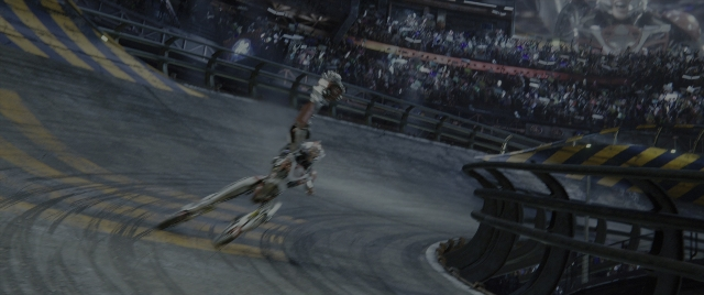 Wide shot frame from Alita: Battle Angel — hat, bicycle, person
