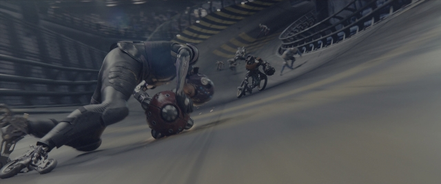 Wide shot frame from Alita: Battle Angel — hat, suit, bicycle