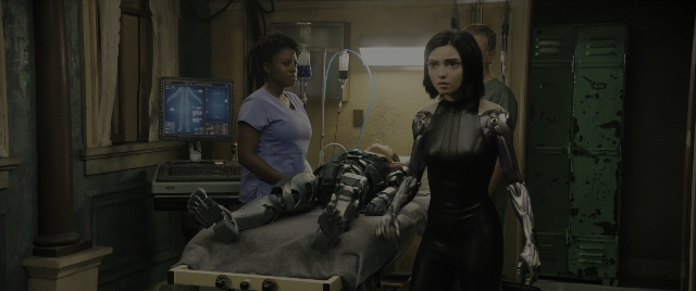 Wide shot frame from Alita: Battle Angel — room, bed, uniform