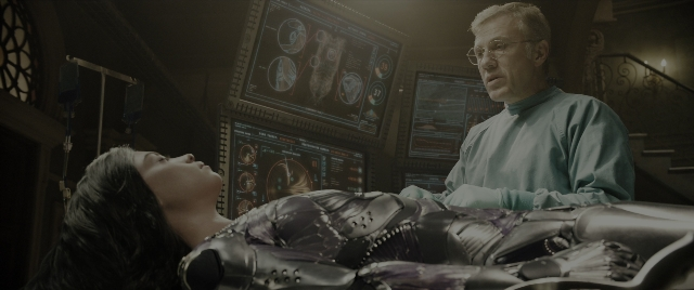 Wide shot frame from Alita: Battle Angel — standing, room, bed