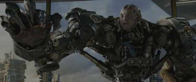 Wide shot frame from Alita: Battle Angel — hand, bird, fight