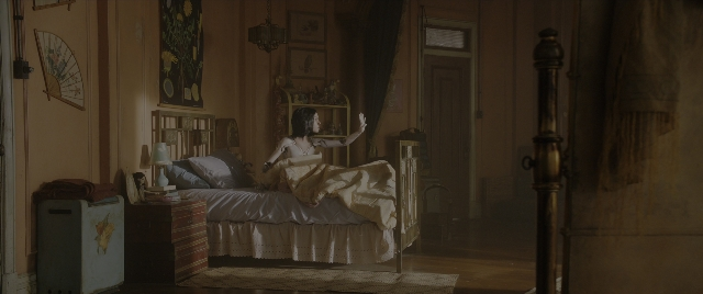 Wide shot frame from Alita: Battle Angel — standing, room, bed