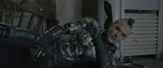 Wide shot frame from Alita: Battle Angel — room, bed, door