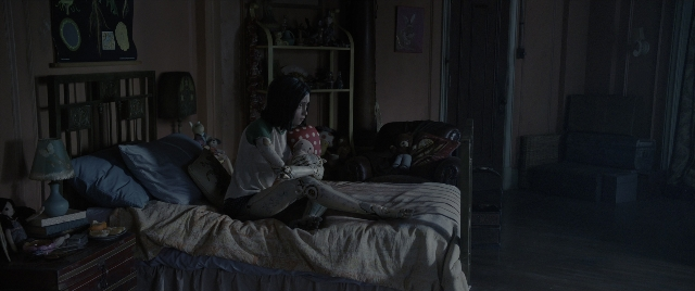 Wide shot frame from Alita: Battle Angel — sitting, room, bed