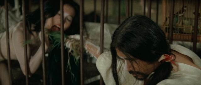 Wide shot frame from Kyôfu kikei ningen: Edogawa Rampo zenshû — hand, face, bird