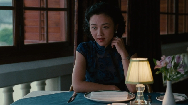 Wide shot frame from Se, jie — sitting, plate, table