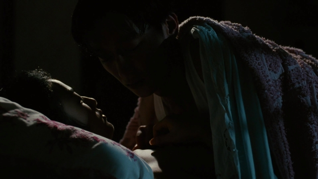 Wide shot frame from Se, jie — room, bed, hair