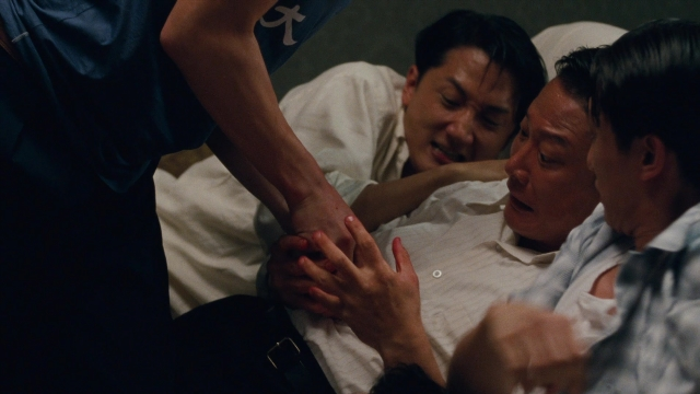 Wide shot frame from Se, jie — bed, hand, shirt