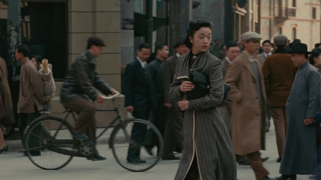 Wide shot frame from Se, jie — walking, street, coat