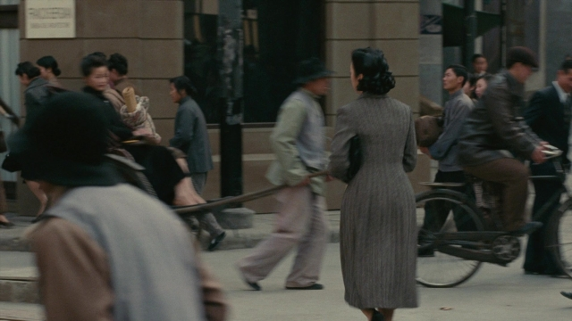 Wide shot frame from Se, jie — sitting, walking, street