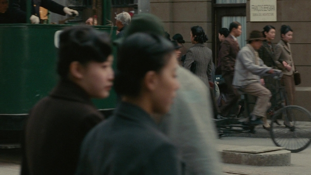 Wide shot frame from Se, jie — standing, walking, street