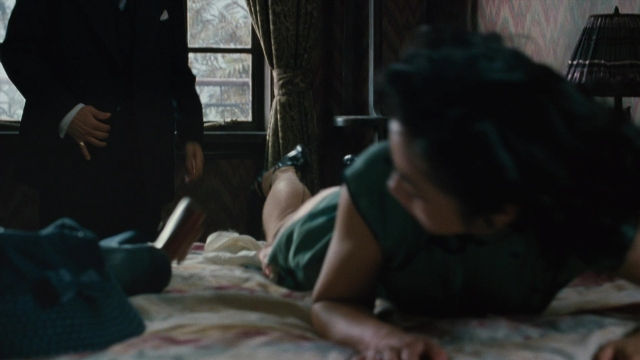 Wide shot frame from Se, jie — standing, bed, suit