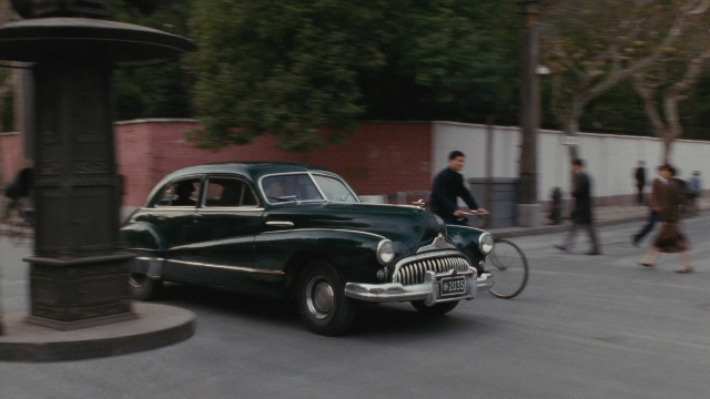 Wide shot frame from Se, jie — walking, street, car