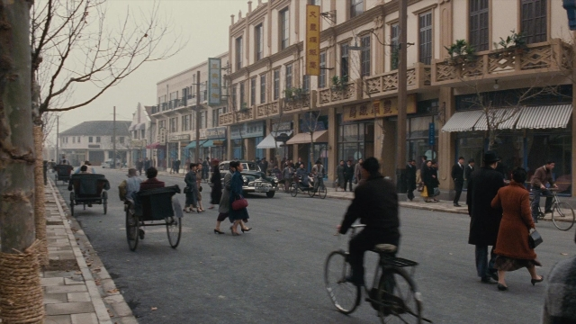 Wide shot frame from Se, jie — sitting, walking, street