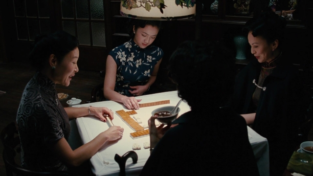 Wide shot frame from Se, jie — sitting, room, table