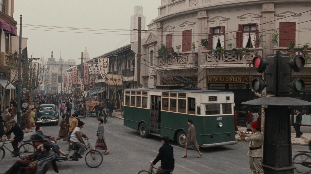 Wide shot frame from Se, jie — walking, street, bicycle