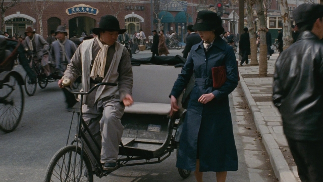 Medium shot frame from Se, jie — walking, street, coat