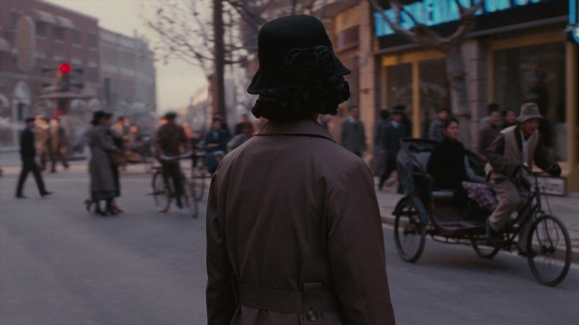 Wide shot frame from Se, jie — walking, street, hat