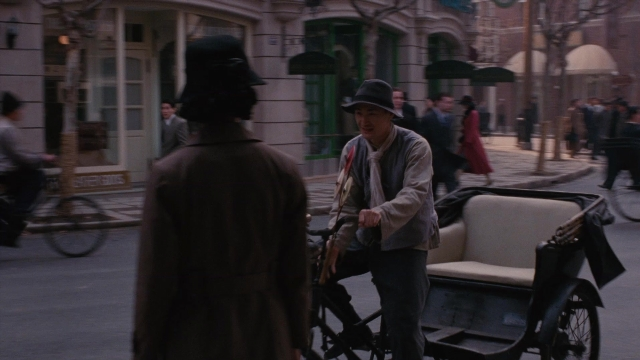 Wide shot frame from Se, jie — sitting, walking, street